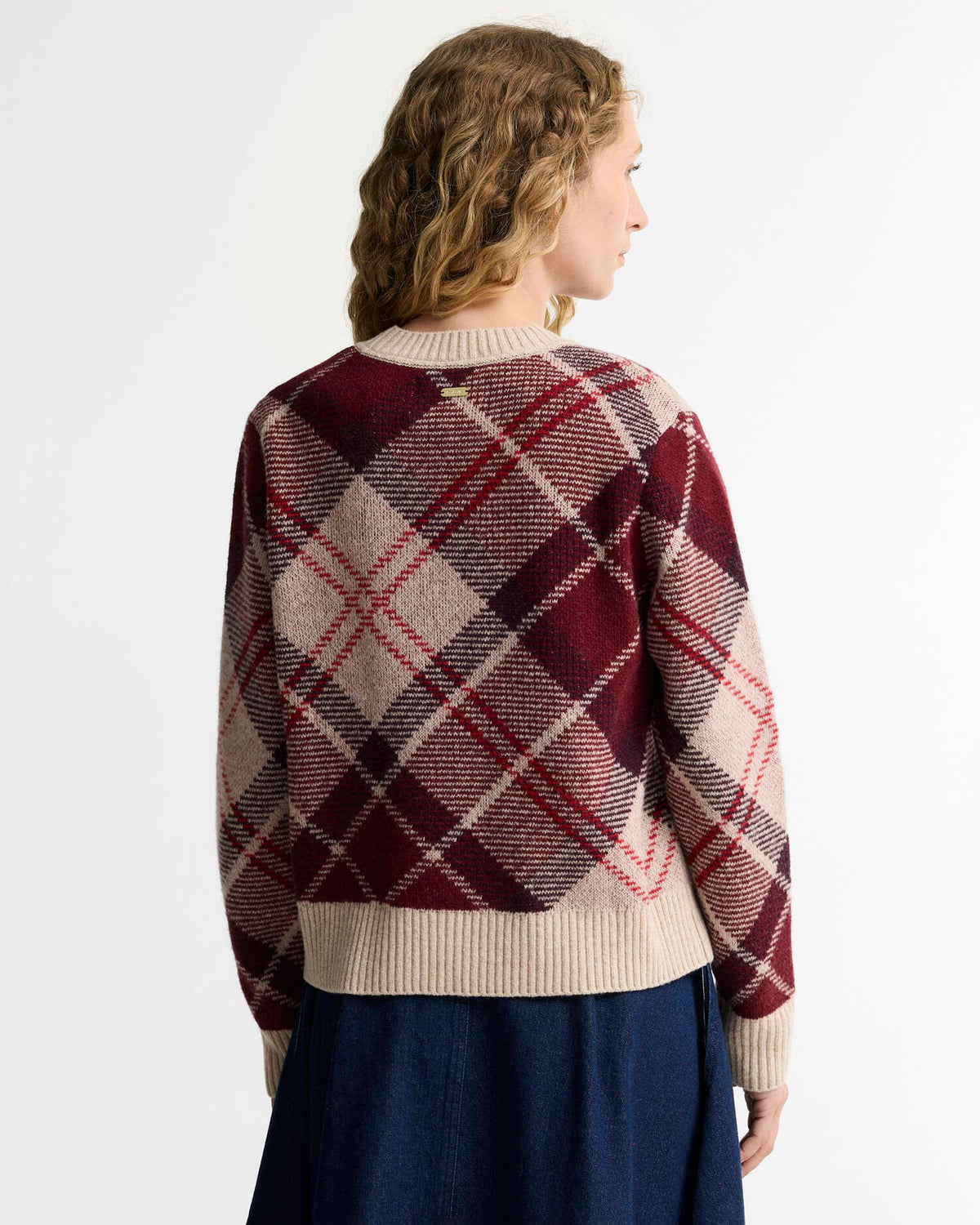 model wearing the Barbour Stevie Tartan Wool Jumper for women in Multi tartan knit