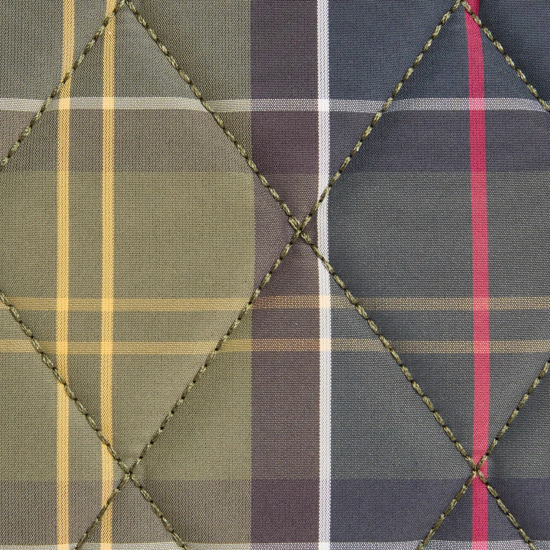 A close-up of the barbour tartan fabric with a multi-colored plaid pattern, featuring stitched diamond quilting. The pattern includes sections of olive green, dark gray, purple, yellow, white, and a bright pink stripe.