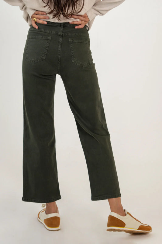 Person wearing olive green pants on a white background