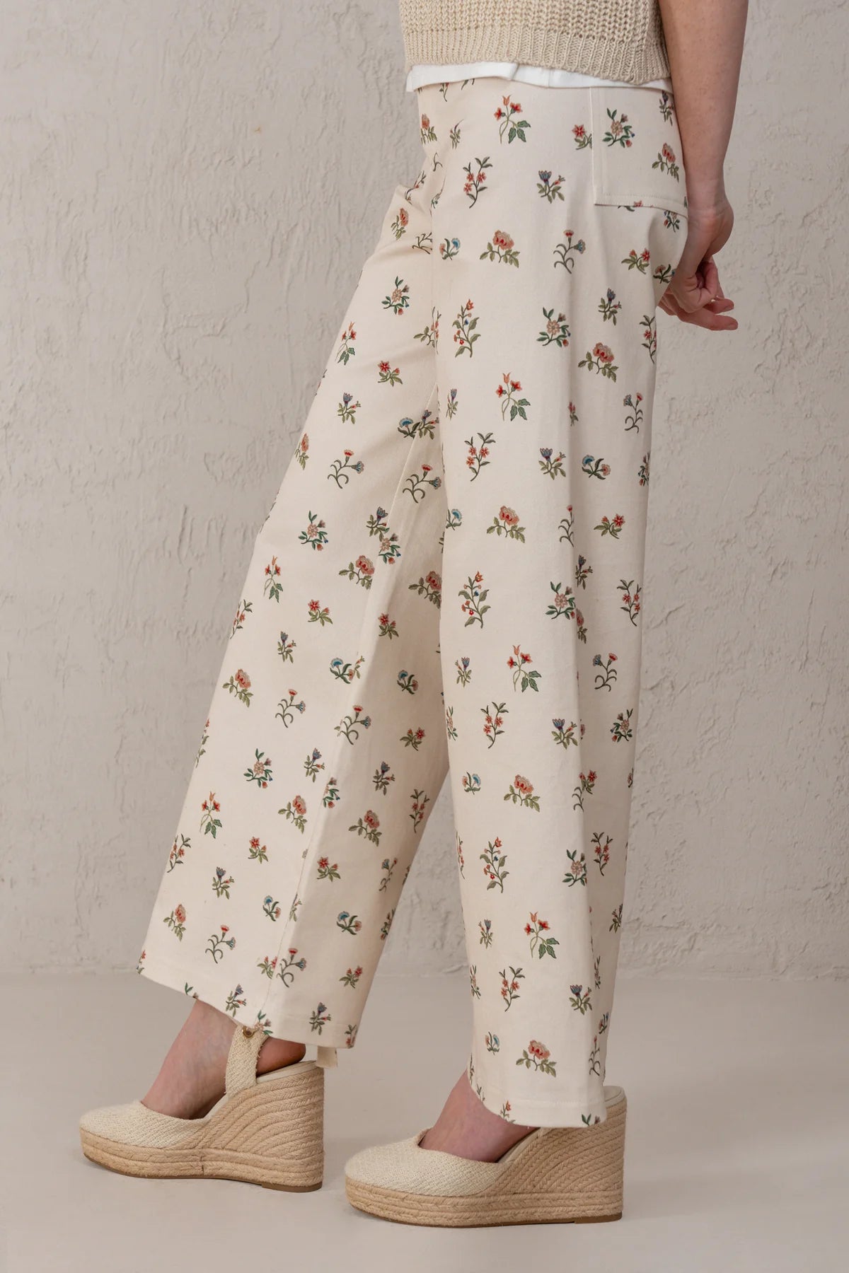 Floral-patterned pants worn by a person on a neutral background